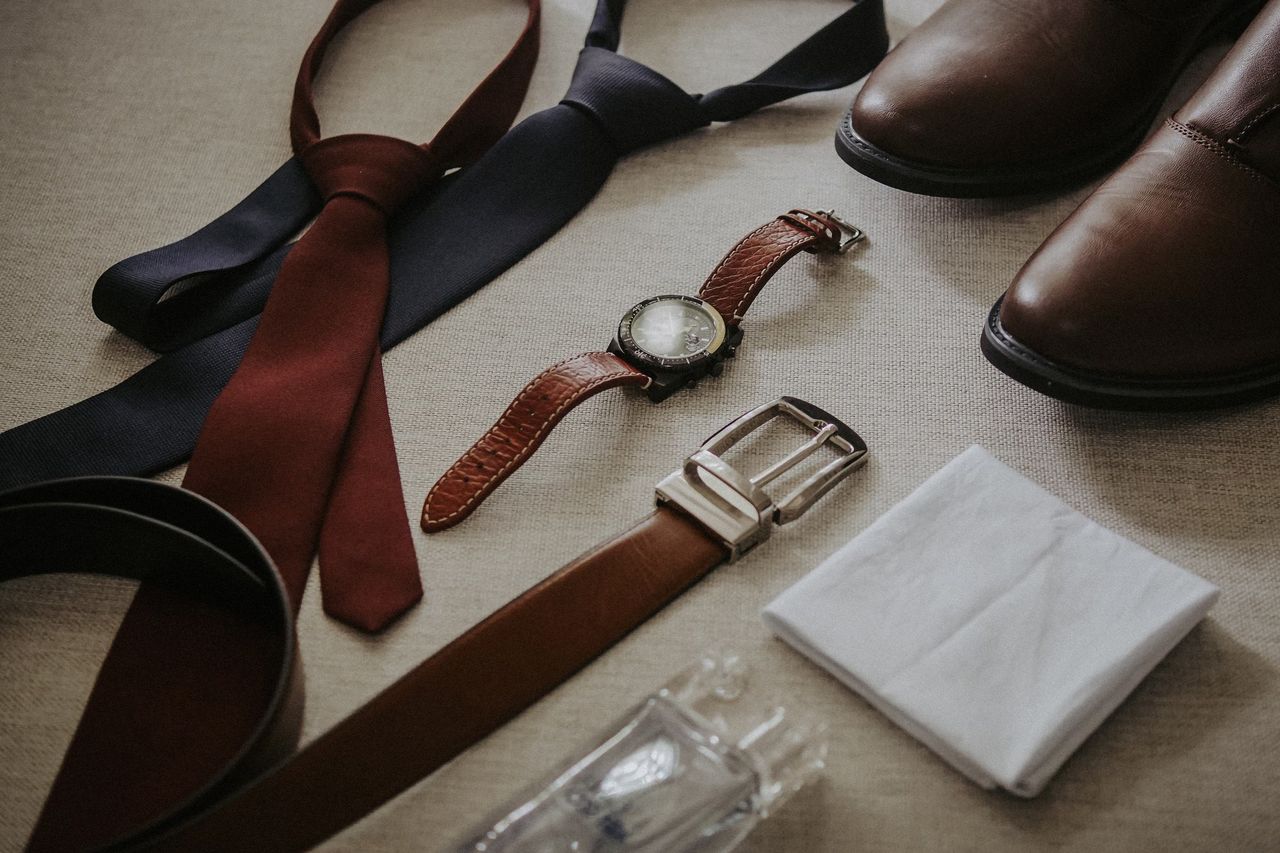 The Art of Drawing Readers In: Your attractive post title goes here Stylish men's accessories including ties, watch, shoes, belt, and handkerchief.